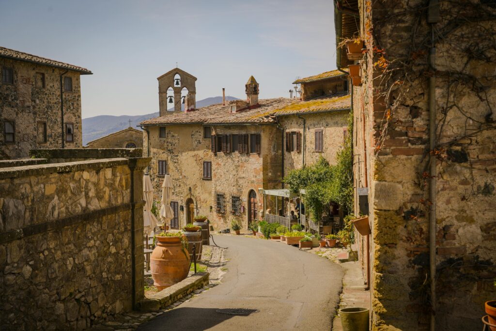 A picturesque street in a historic Tuscan village with stone buildings and rustic charm.
